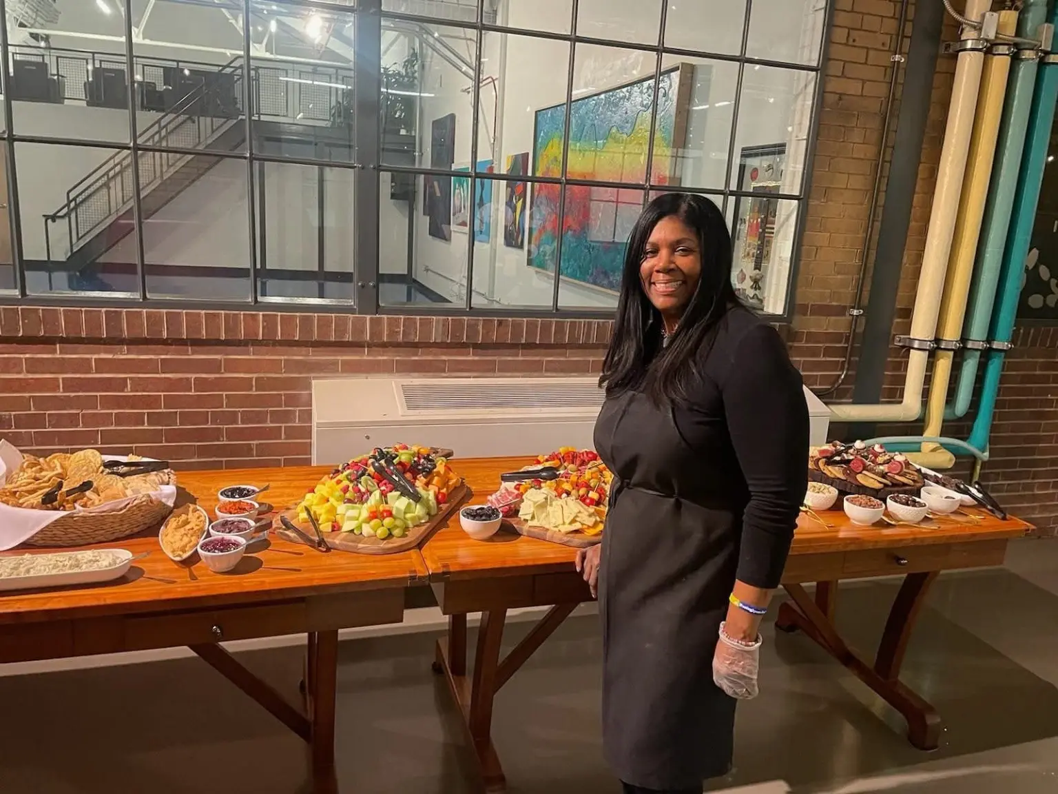 Carla El standing beside a finished catering spread